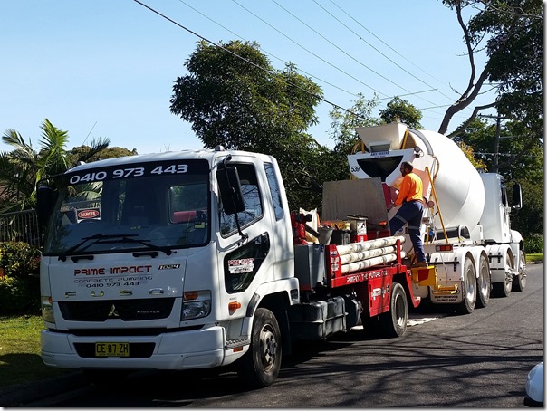 Concrete mixer truck at the front of the house